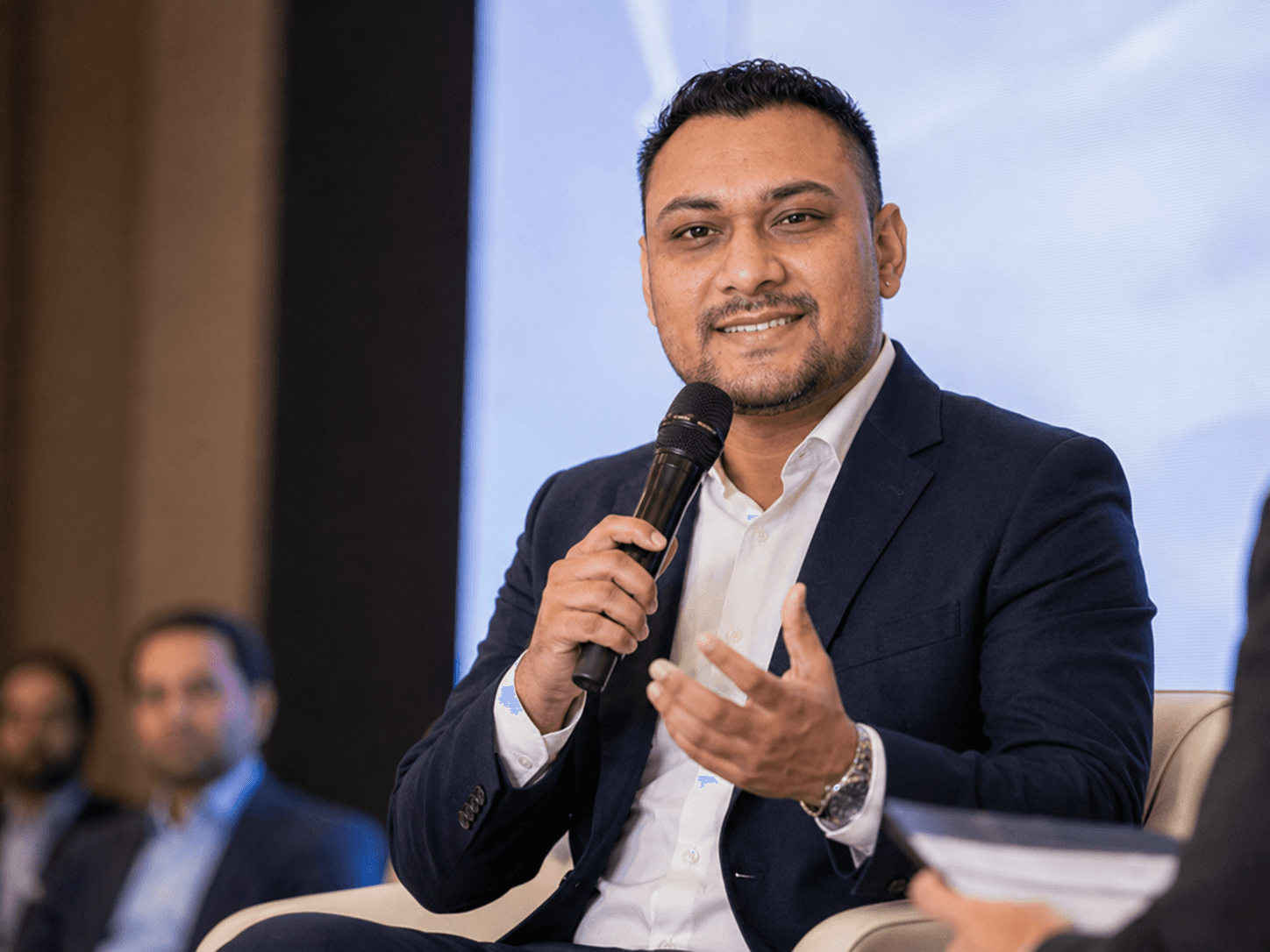 Dhanesh Patel speaking with colleagues at an event